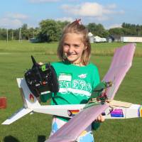 green team student poses with their plane